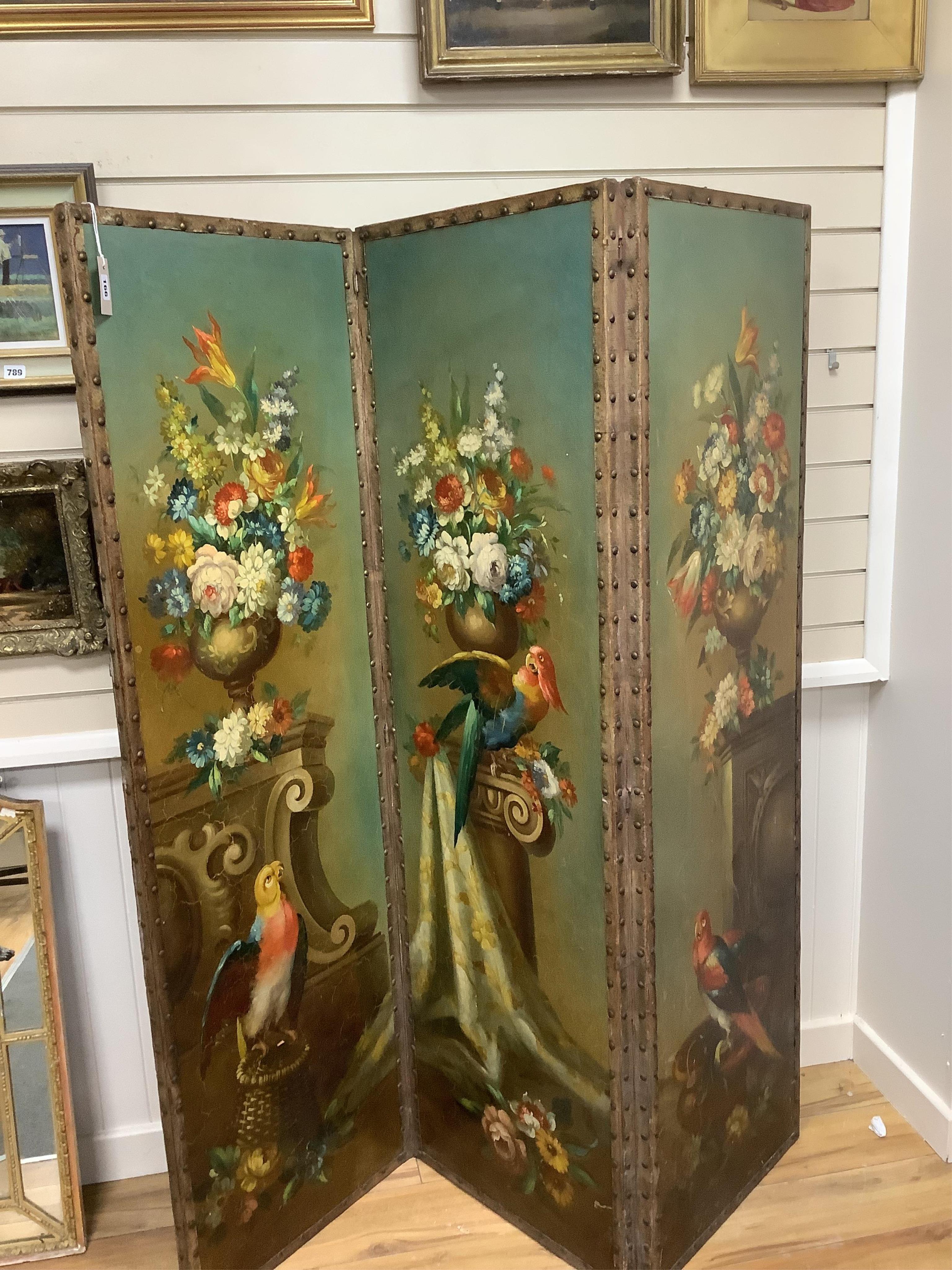 An early 20th century painted canvas three fold dressing screen decorated with parrots among vases of flowers, width 50cm, height 169cm. Condition - good